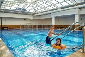 Kids swimming in a community recreation pool.