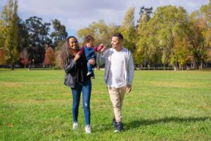 Parents with a young child walking in the park